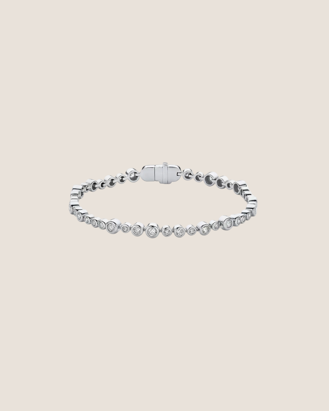 A silver tennis bracelet featuring a row of small round-cut clear stones along the front, with a polished clasp closure, shown on a plain white background.