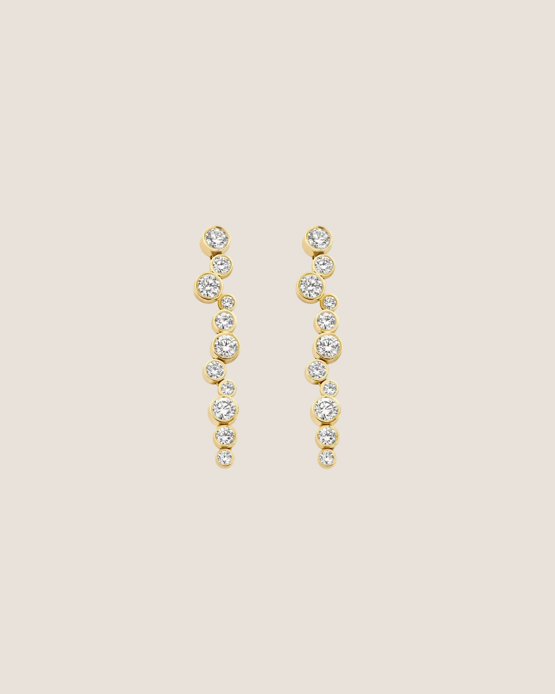 A pair of gold drop earrings with a series of small clear round-cut stones, displayed on a solid white background.