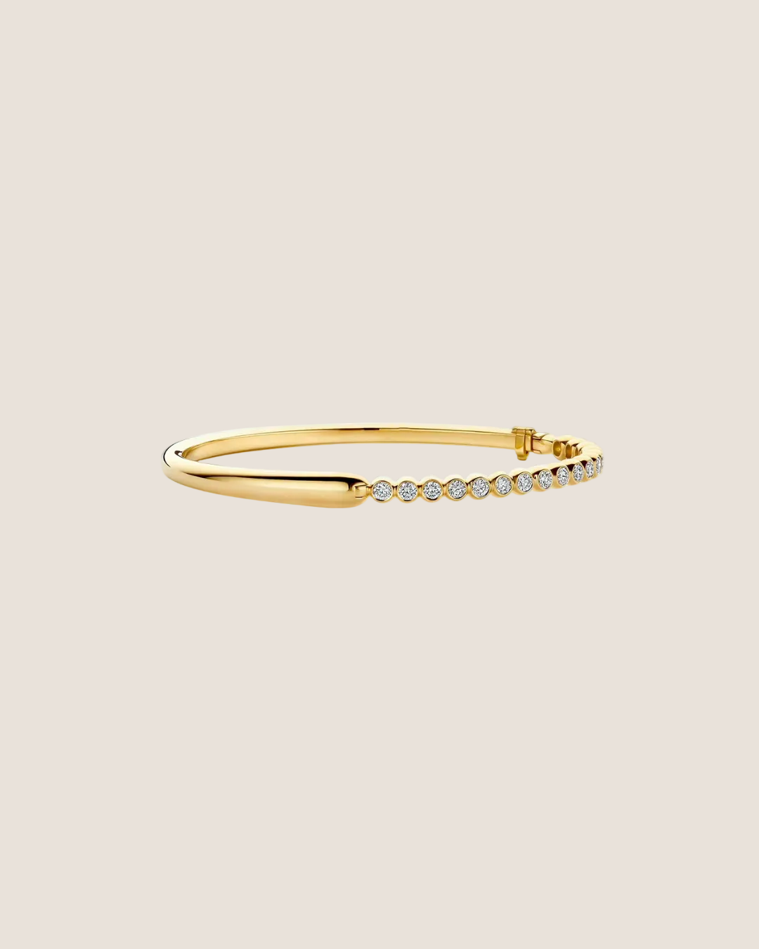 A slim gold bangle bracelet featuring a row of small clear pavé-set stones along one side, shown on a plain white background.