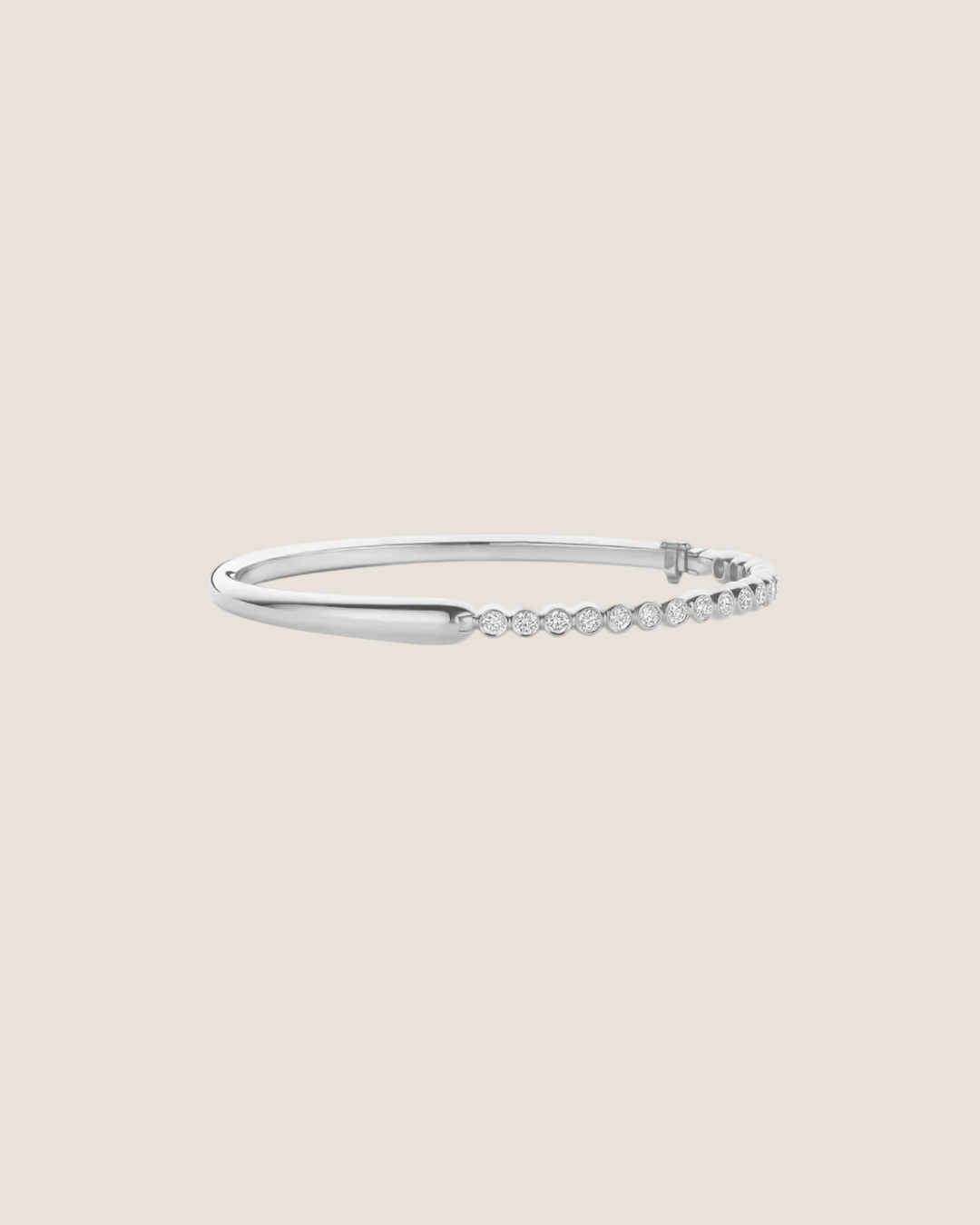 A silver-toned hinged bangle bracelet featuring a row of small clear stones along one side, displayed against a solid white background.
