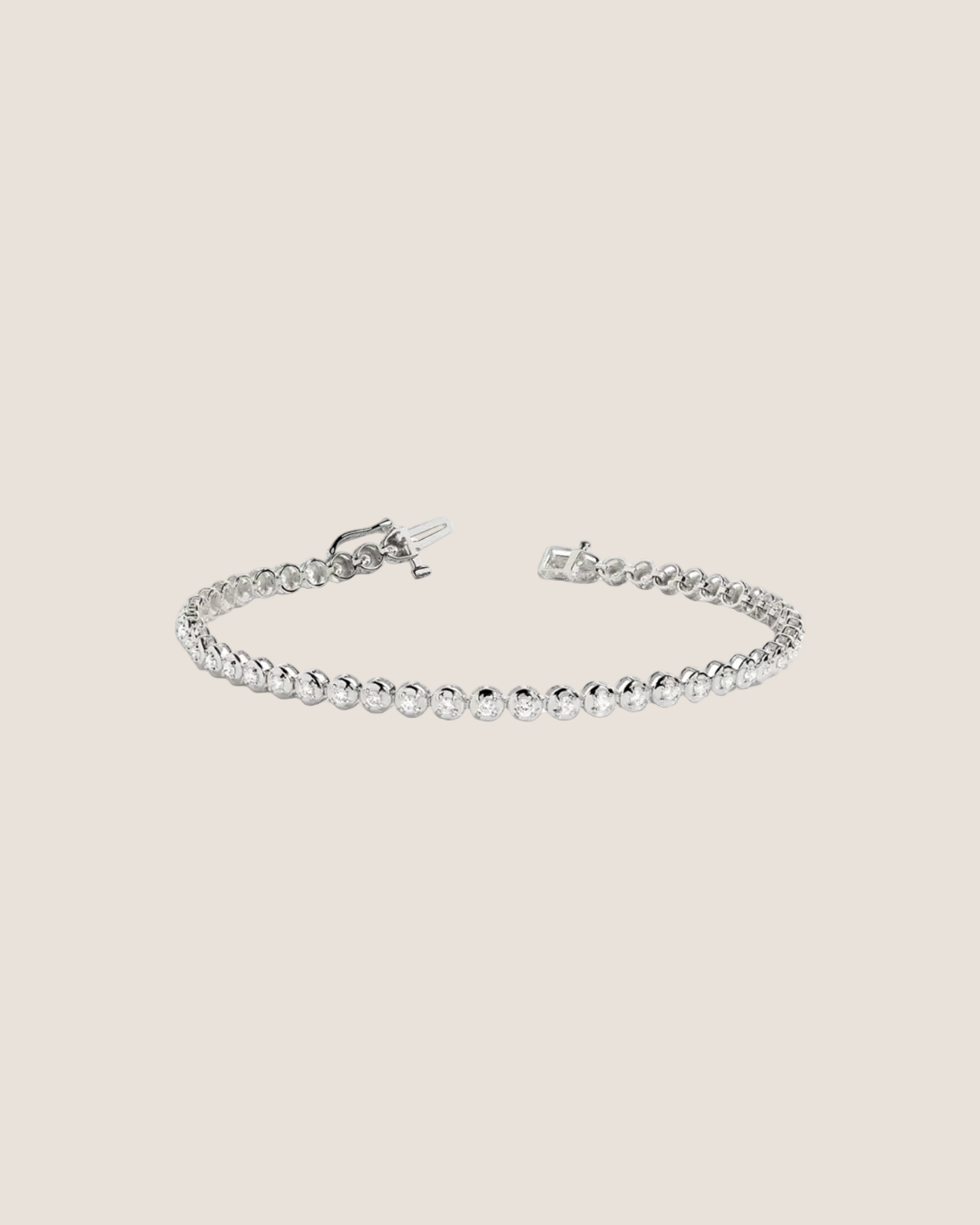 A silver tennis bracelet with a beaded link design and a toggle clasp, shown on a plain white background.